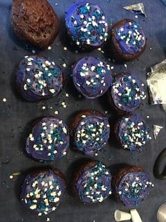 cupcakes with purple frosting and sprinkles