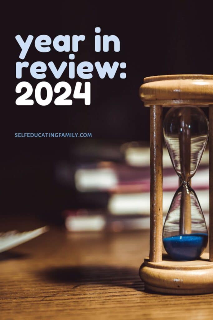 hourglass and books with year in review title