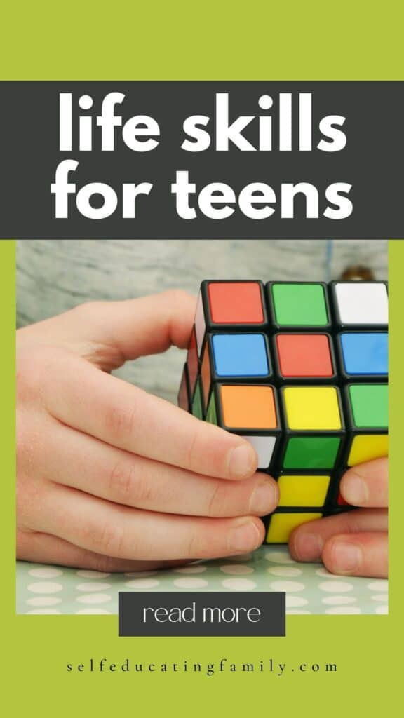 kid's hand on rubik's cube