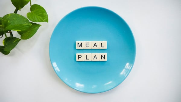 tile letters spelling meal plan on blue plate