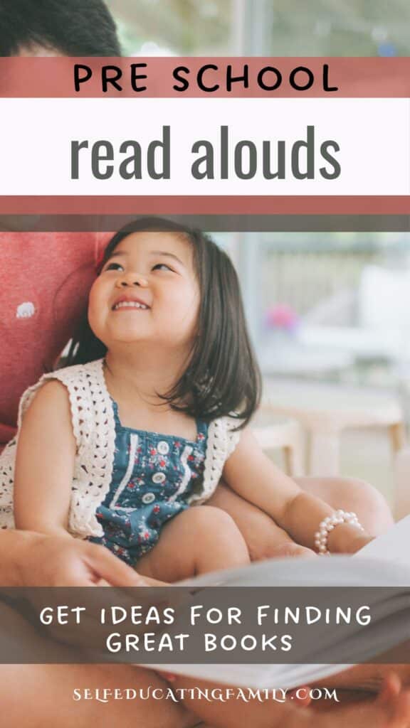 Little girl looking up at dad as he reads to her