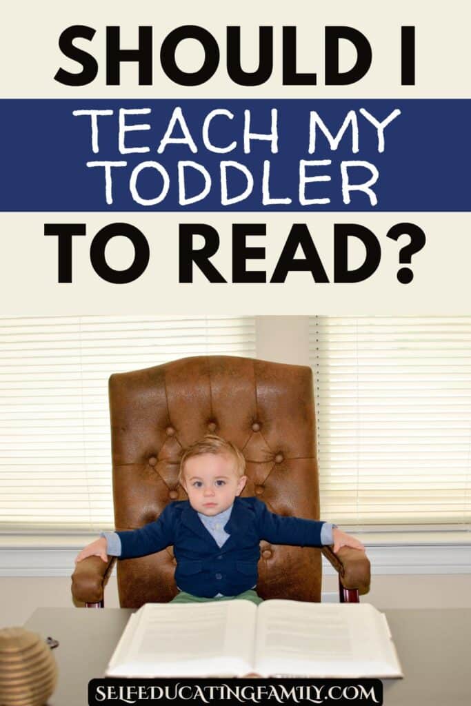 toddler wearing suit in executive chair with big book