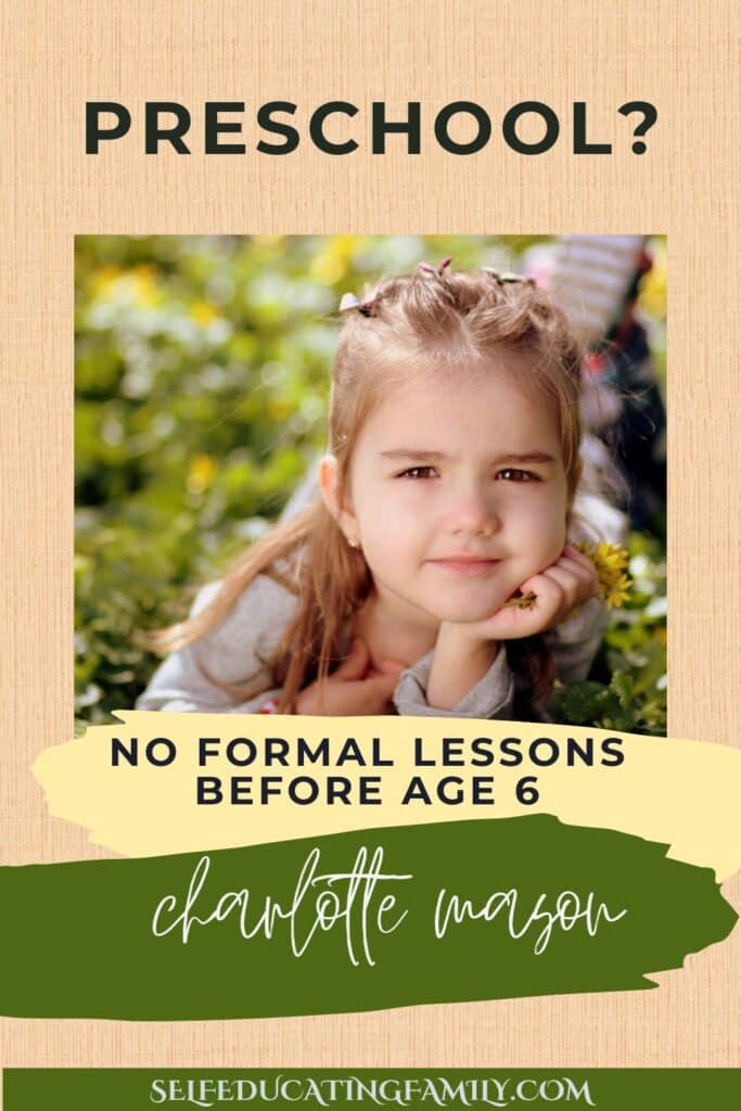 preschooler laying on grass with chin on hand