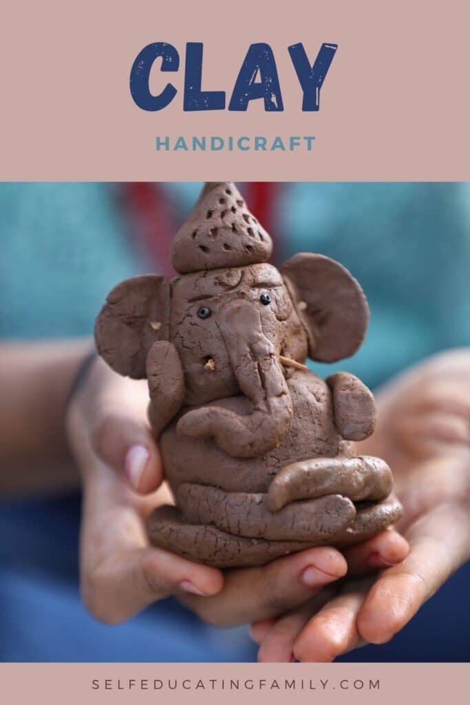 hands holding clay model of fun looking elephant