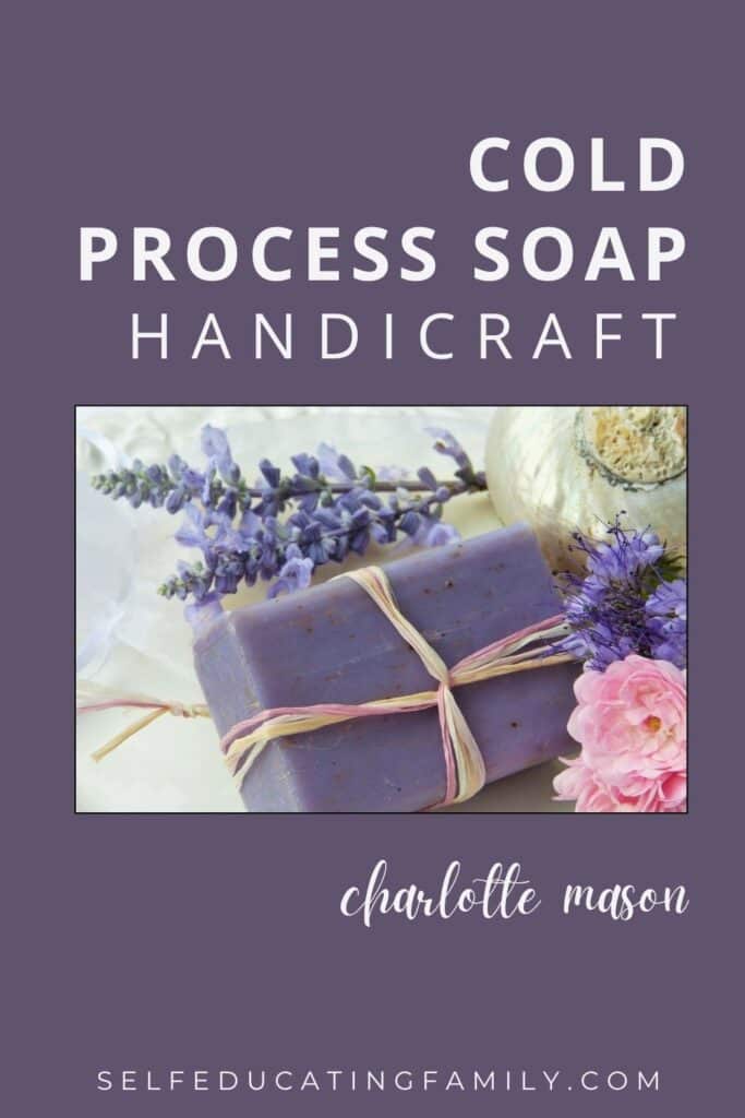 purple soap bar tied with jute sitting next to pink and purple flowers