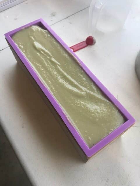 pale green cold process soap just pured into purple silicon block mold