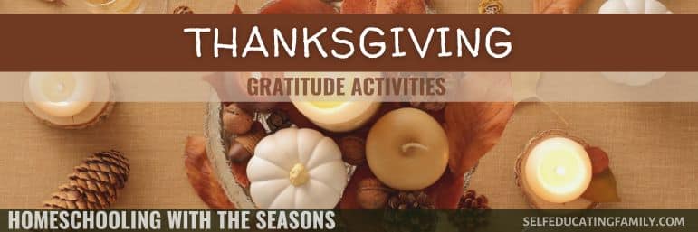 thanksgiving table with candles and white pumpkin and leaves and nuts and pine cones