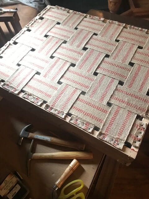 ottoman frame with new webbing and tools next to it