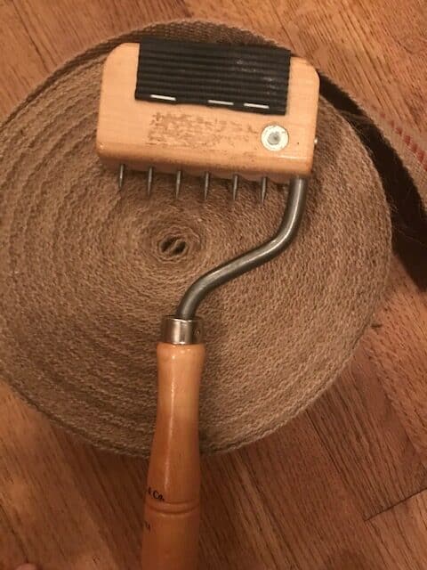 upholstery web stretcher tool on roll of webbing