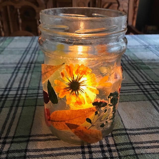 final jar with illuminated to glow through the leaves and flowers